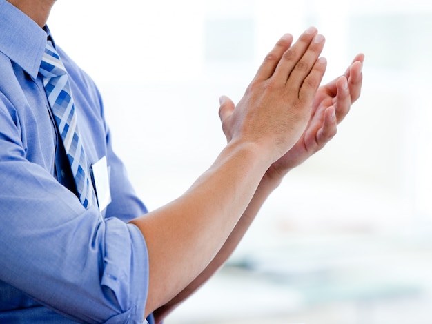 Close-up of a businessman clapping 