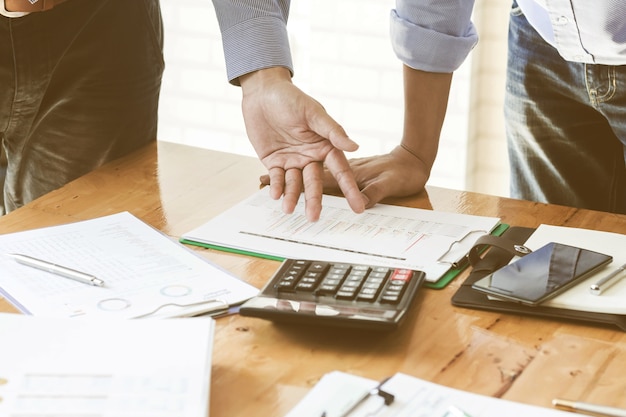 Close-up of businessman explaining a financial plan to colleagues at meeting