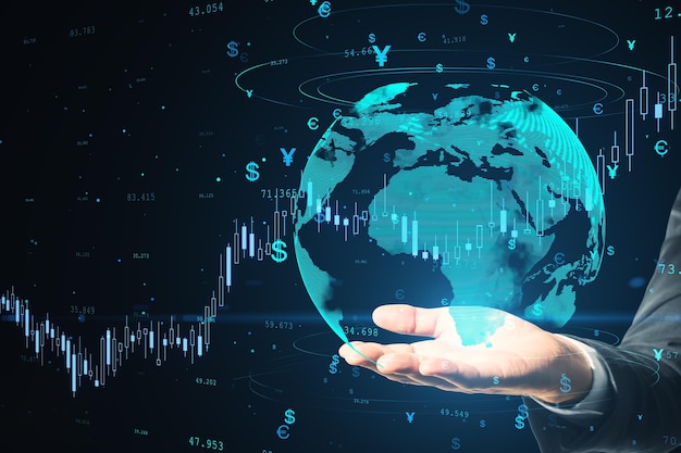 close up of businessman hand holding creative globe hologram with money signs and candlestick graph and dark background global trade finance currency and future concept double exposure