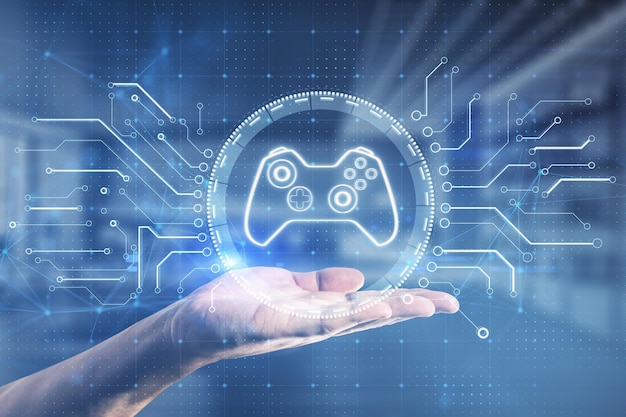 Close up of businessman hand holding creative joystick or gamepad hologram on blurry office interior background Esport gaming and fun concept Double exposure