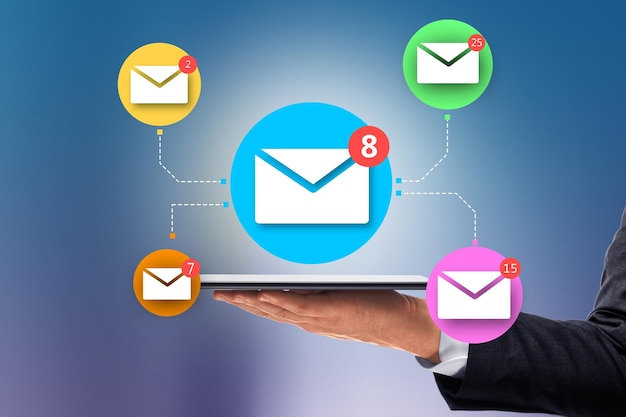 close up of businessman hand holding tablet with abstract email network on blue wall background social networking and communication concept