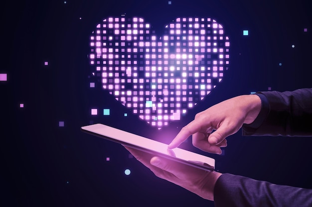 Close up of businessman hand pointing at cellphone with abstract glowing purple pixel heart on blurry background Health cardiology and game interface concept