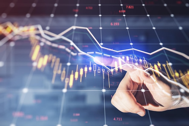 Close up of businessman hand pointing at falling forex chart with index on blurry background Crisis and declining trade concept Double exposure