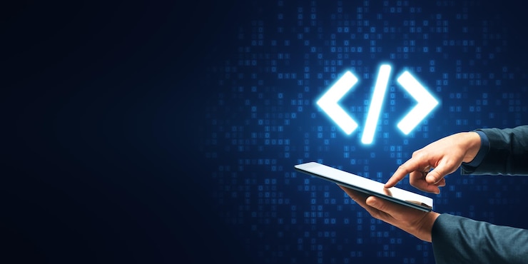 Close up of businessman hand pointing at tablet with glowing programming code on blue binary coding background with mock up place Program and software development concept
