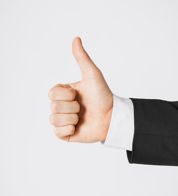 close up of businessman hand showing thumbs up