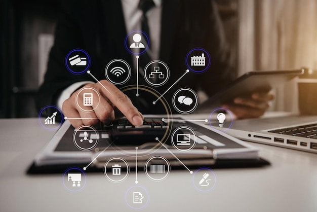 Close up businessman hand using calculator and working with tablet calculate about finance accounting at home office finance accounting concept