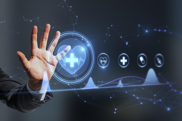 Close up of businessman hand using creative polygonal medical interface hologram on blurry background Online healthcare cardiology and technology concept Double exposure