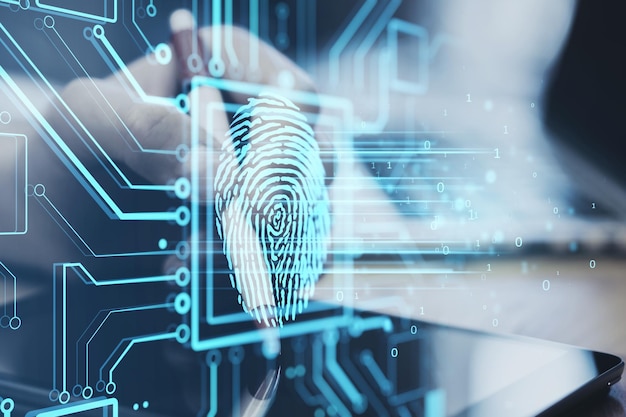 Close up of businessman hand using digital pad with glowing
fingerprint circuit hologram on blurry background id and database
concept double exposure