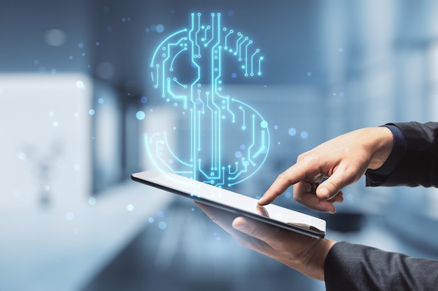 Close up of businessman hands holding and pointing at cellphone with abstract glowing blue circuit dollar hologram on blurry bokeh office interior background. Online banking and financial technology c