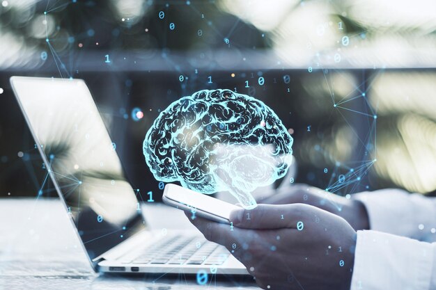 Close up of businessman hands using laptop and smartphone with creative polygonal brain hologram on blurry background Neurology and anatomy concept Double exposure