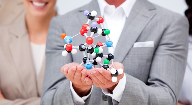 Close-up of a businessman holding a molecule 