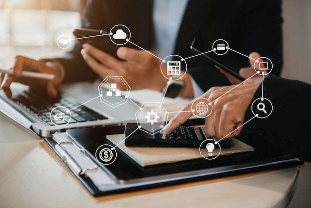 Close up Businessman and partner using calculator and laptop for calculation finance tax accounting statistics and analytic research concept