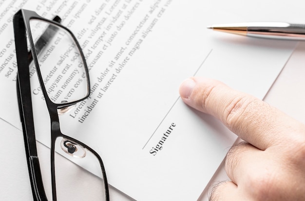 Close up of businessman pointing to the signature line in contract