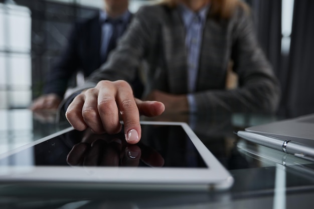 close up businessman pressing his finger on the screen of the digital tablet