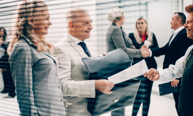 Close up businessman receiving a document from an employee of the company