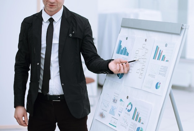 Close up businessman shows information on flipchart