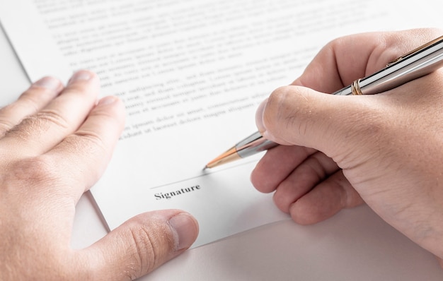 Close up of businessman signing contract