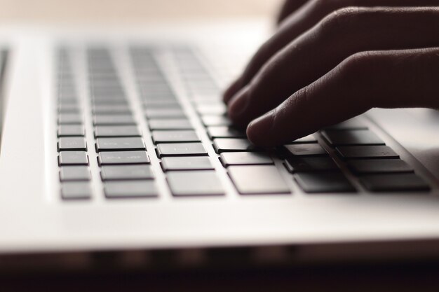 Close up. businessman typing on laptop keyboard.