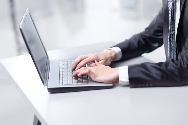 close up. businessman typing on laptop. people and technology.