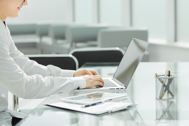 Close up businessman typing on a laptop