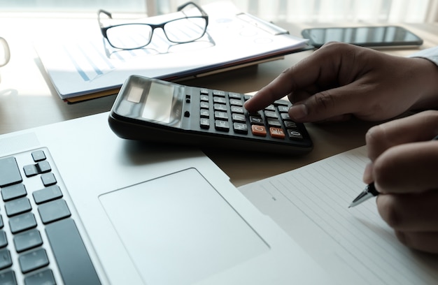 Close up businessman using calculator on  finance  