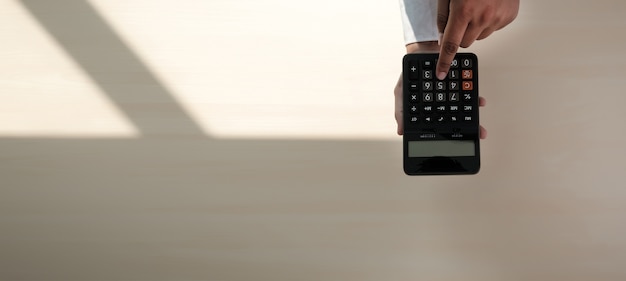 Close up businessman using calculator 