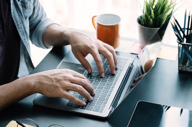 Close up businessman using laptop computer