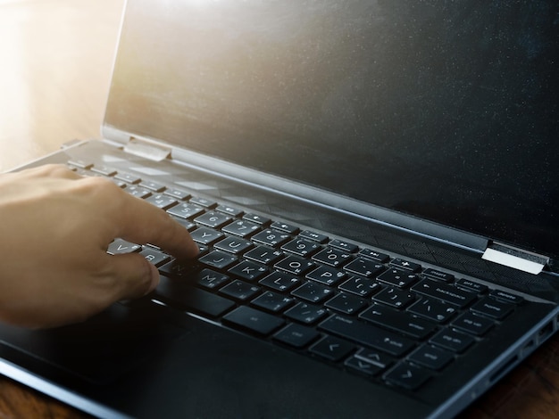 Close up businessman using laptop for working on the table