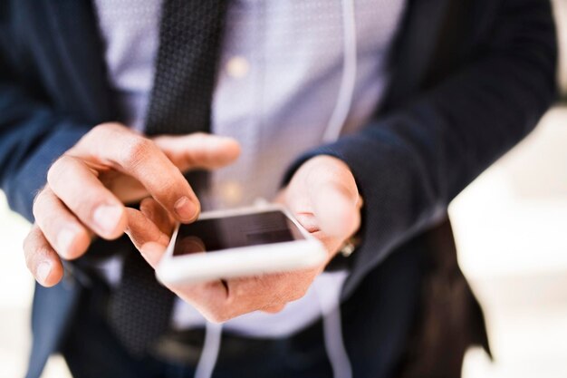 Close-up of businessman using smartphone