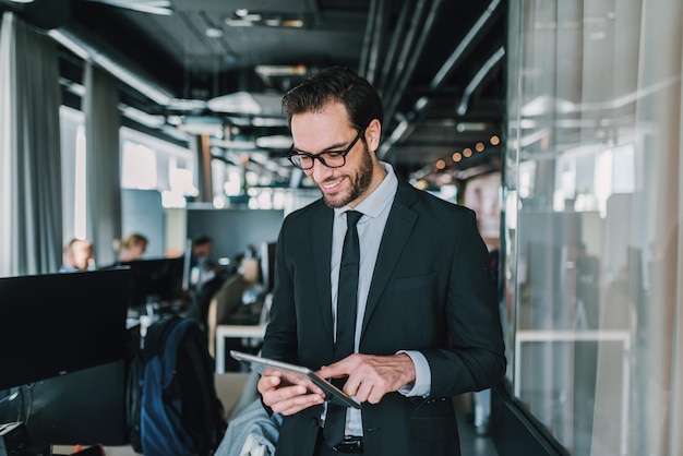 Close up of businessman using tablet.