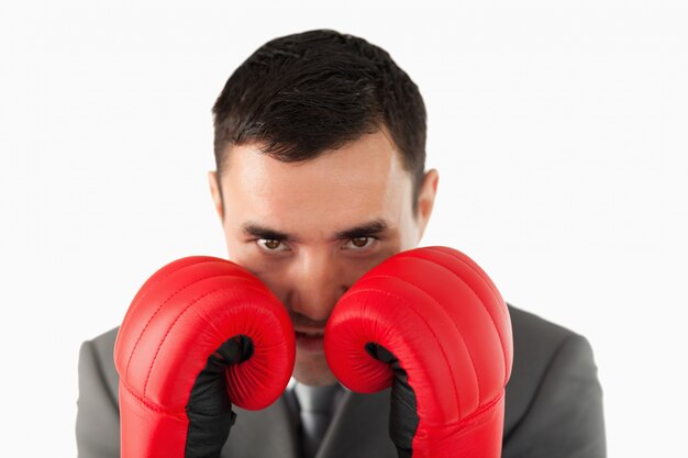 Close up of businessman with boxing gloves taking cover