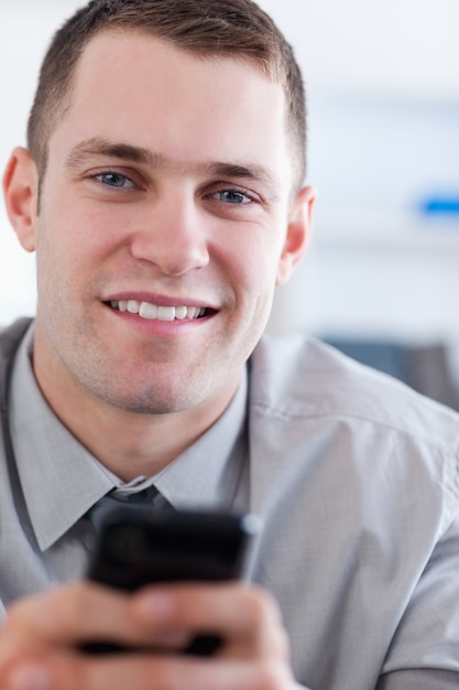 Close up of businessman with mobile phone in his hans