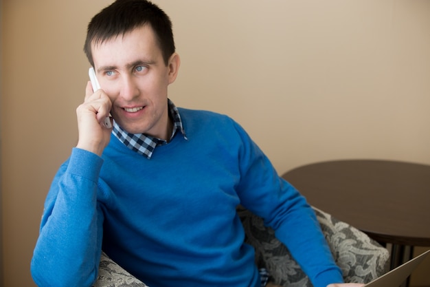 Close-up of businessman with smartphone and blue jersey