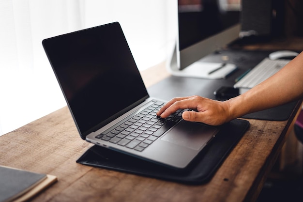 Close up of businessman working and login on laptop