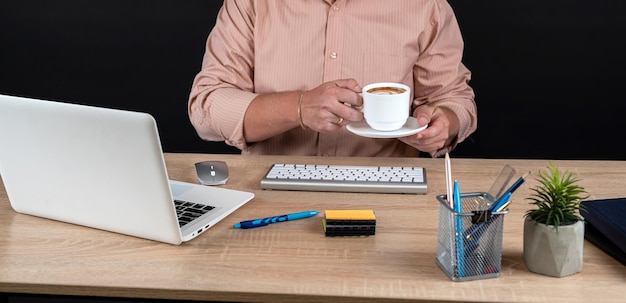 close up of businessman working at office with financial documents chart statistic with laptop