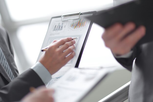 Close up businessman working with graph data at office.