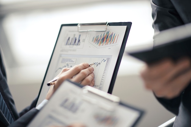 Close up businessman working with graph data at office.