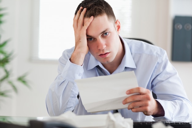 Close up of businessman worried about invoice