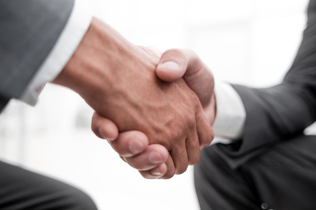 Close up of businessmen shaking hands business success ideas concept