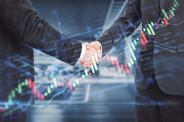 Photo close up of businessmen shaking hands in office with creative candlestick forex chart