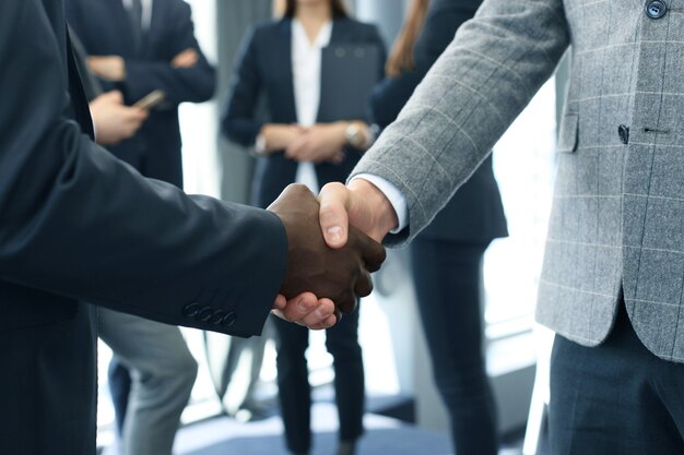 Close up of the businessmen shaking hands.