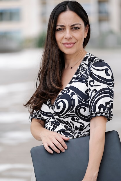 Close-up of a businesswoman holding a laptop