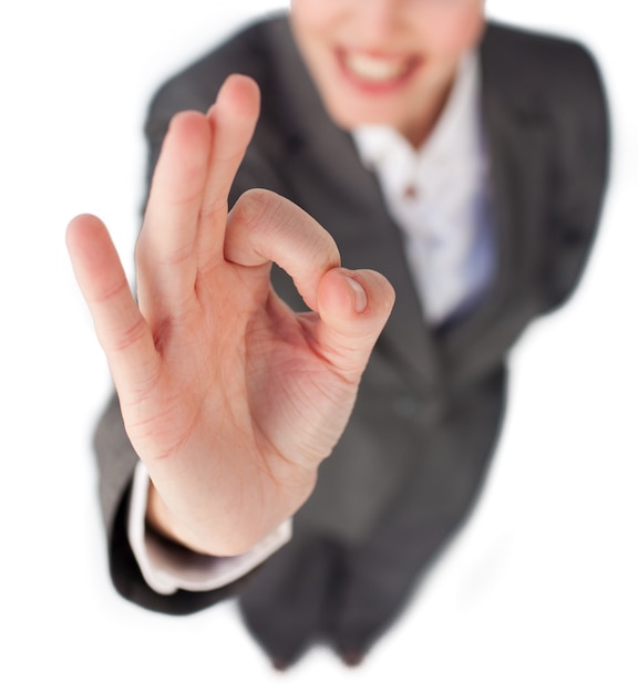 Close-up of a businesswoman showing OK sign 