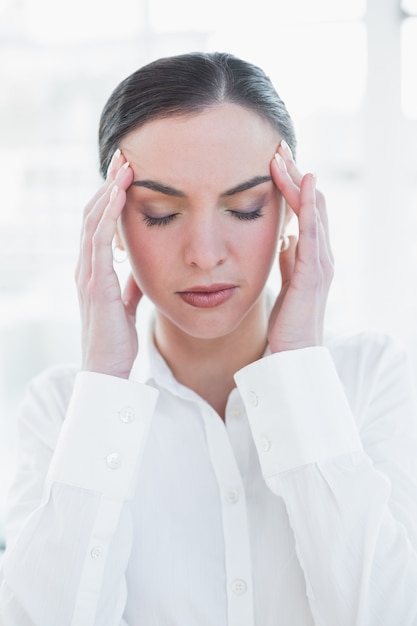 Close up of businesswoman suffering from headache