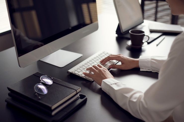 Photo close up. businesswoman working on laptop computer keyboard in office.