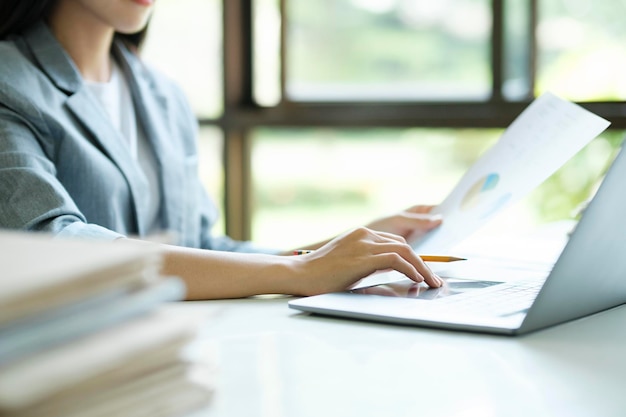 Close up of Businesswoman working at office using laptop