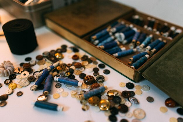 Photo close-up of buttons and threads on table