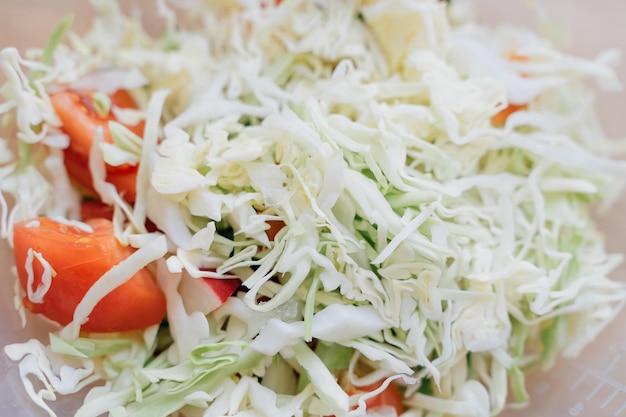 Close up of cabbage green salad with cucumber and tomatoes