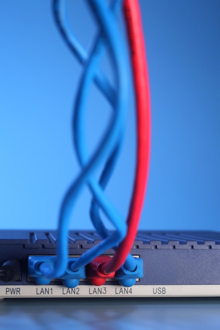 फोटो close-up of cables and router against blue background