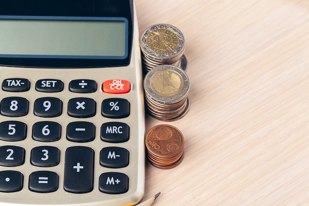 Close up of a calculator and coins on a business